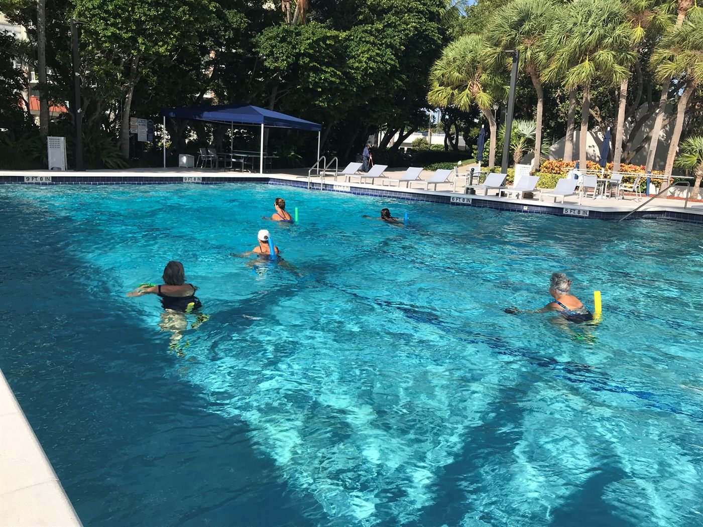 AquaFit Sports aquatic fitness class — a group training together in an outdoor pool