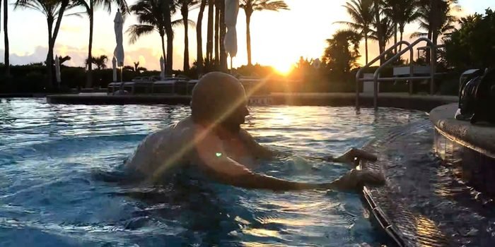 Client training at the pool wall at sunrise after ankle replacement